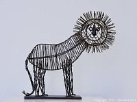 Side angle of metal wire lion sculpture showing body framework and spiked mane.