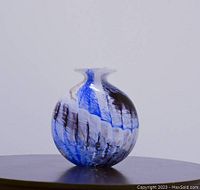 Front and side view of the signed Phoenician Mdina Malta art glass vase showing blue, black, white, and accent colors with flared rim.