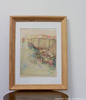 Image of the framed vintage watercolor painting of harbor scene, showing natural wood frame, matting and the painting details.