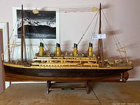 Full view of wooden Titanic ship model on display stand with nameplate
