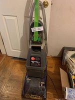 Full view of the Hoover SteamVac LS SpinScrub upright steam cleaner showing main body, hose, handle, and base with scrub brushes visible.