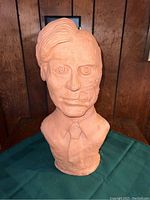 Front view of clay bust of Harvey Dent showing detailed facial features and half face disfigured.