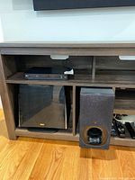 LG BP550 3D Blu Ray player, Sony speaker system including subwoofer and speaker on a wooden stand.