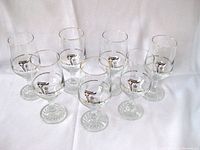 Set of seven clear glasses with gold-rimmed edges and 1988 Calgary Olympics torch logo
