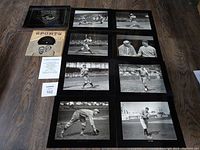 Eight vintage black and white photos of baseball legends with a sports record and Certificate of Authenticity on wooden floor