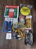 Photo showing 8 home improvement items including Fluidmaster access panel, Lowe's level, Dixon crayons, bungee cords, safety glasses, weather stripping, and a smoke detector.