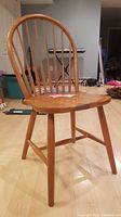 Full wooden spindle back side chair showing overall design and structure.