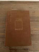 Front cover of the Pearl Buck book Sons, showing brown cloth cover with gold embossed title and author.