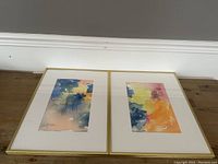 Pair of two signed watercolour paintings displayed side by side, one framed and one unframed, showing overall condition and scale.