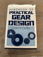 Front cover of Handbook of Practical Gear Design by Darle W. Dudley with title and gear illustrations.