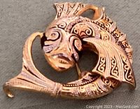 Brooch side view showing detailed koi fish design with gold and black damascene pattern