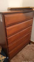 Front view showing five closed drawers with recessed pulls