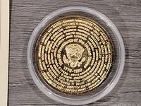 Reverse of the medal displaying the U.S. Presidential Seal in the center, surrounded by the names of presidents in spiral text.