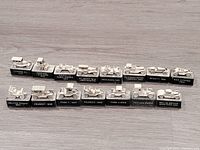 Photo of all 15 classic car pencil sharpeners in a row on a wooden surface.