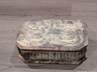 Full view of INCOLAY faux marble rectangular box with lid showcasing raised 3D relief of forest animals and birds on top and carved patterns on sides.