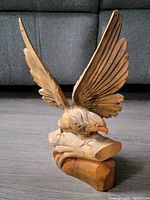 Front angle view of the 12 inch tall wood eagle carving showing wings spread and detailed feathers.