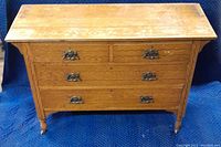 Full front view of the antique sideboard dresser showing overall condition, decorative wood inlay, metal hardware, and turned feet.