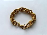 Top-down view of gold plated Milor bronze link bracelet with textured and smooth alternating oval links, showing the lobster claw clasp.