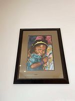 Front view of the custom framed watercolor portrait of a smiling young girl, showing the full frame and matting.