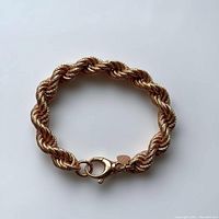 Top view of Italian Milor bronze bracelet with twisted rope link design and lobster clasp, showing full circular form.