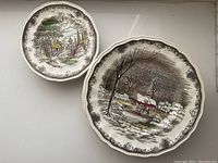 Overview of two plates, one dessert and one dinner plate showing crackle glaze and pastoral scene
