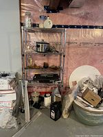 Five-tier chrome wire shelving unit loaded with kitchen items.