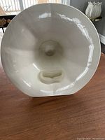 Front view showing the wide bell and iPhone slot inside