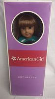 Front of original box showing doll's face through circular window with American Girl branding and 'Just Like You' text.