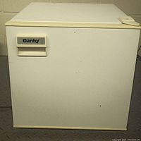 Front view of the Danby mini fridge showing closed door with brand label