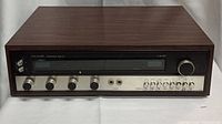 Full front view of the Hallmark CW301 stereophonic receiver showing wood casing and front panel controls including selector knobs and large tuning display.