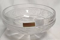 Close-up of a clear glass bowl showing detailed etched decorations and original Nachtmann label