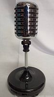 Front view of vintage-style desktop microphone with chrome grille and black base