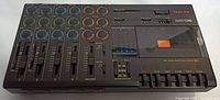 Full top view of Tascam Porta05 Mini Studio with sliders, knobs, buttons and cassette window.
