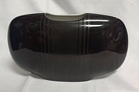 Black porcelain vase showing glossy black finish with subtle vertical lines and rectangular curved form with wide open top.
