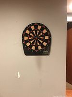 Electronic dartboard hanging on wall, showing overall appearance