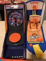 Photo showing ball toss game with colorful spinning target and metal balls