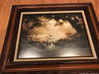 Framed nature painting showing two deer near a stream surrounded by trees in warm, earthy tones.