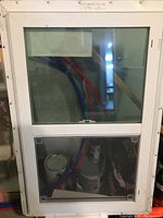 Clear photo of a white framed new work window with flanges, single glazed with two sections.