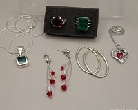 Overview of all jewellery items including rings on foam holder, necklaces and earrings laid out