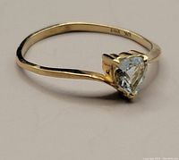 Close-up image of the 10kt gold ring showing the heart-shaped aquamarine from a side angle.