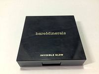 Front of the cosmetic compact showing brand 'bareMinerals' and product name 'INVISIBLE GLOW' in light gold text on black case.