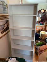 Front view of white Billy bookcase showing five shelves spaced evenly, clean and intact.