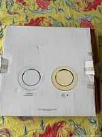 White cardboard box showing front with two charger plate illustrations indicating the available colors and design for the charger plates inside.
