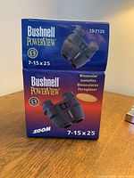 Front and top side of original Bushnell PowerView Zoom 7-15x25 binoculars retail box showing branding and product image