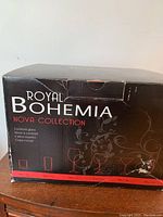 Box front showing Royal Bohemia Nova Collection label, indicating these are cocktail glasses with brand and series information.