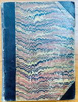 Front cover shows marbled paper design with black leather spine and corners, light surface wear.