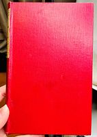 Front cover of the book, bright red with a gold embossed spine label.