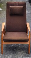 Front view of brown upholstered lounge chair on oak frame