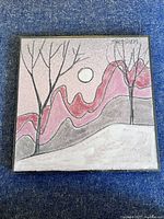 Front view of the ceramic tile showing the landscape with trees, full moon, and pink and gray hills. Signed top right.
