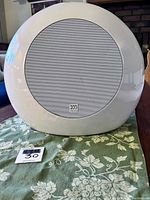Front view of white circular Morel SoundSub PSW8e subwoofer speaker.